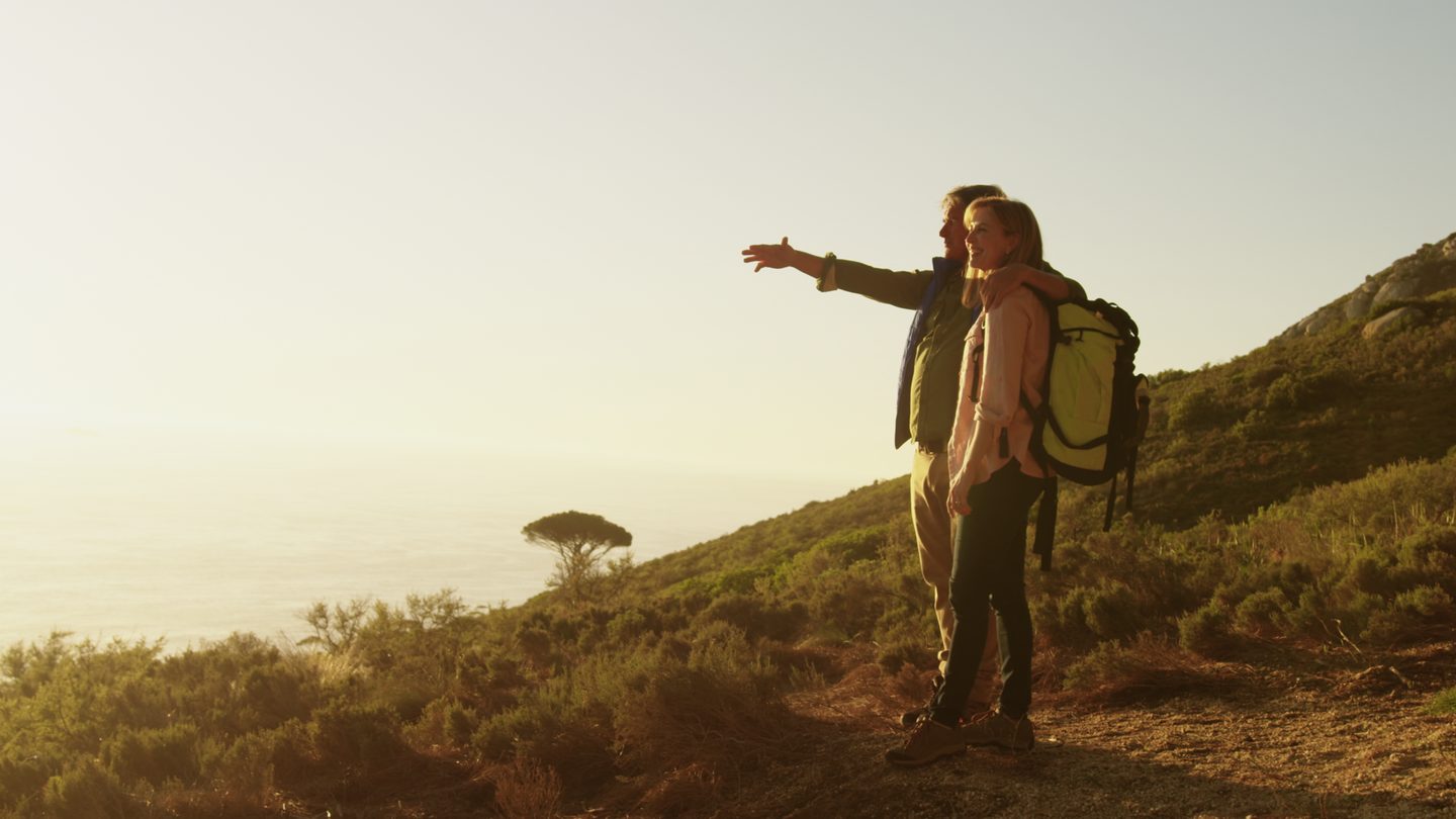 A couple looking out over the coast during a hike (illustrative photo)